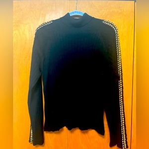 Turtleneck sweater, crochet sleeve detail.